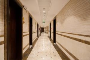 a hallway of a building with a tile floor at Al Khulfaa Al Masy - فندق الخلفاء الماسي in Makkah +50 photos