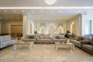 a lobby with couches and tables in a building at Al Khulfaa Al Masy - فندق الخلفاء الماسي in Makkah