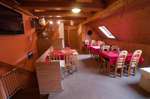 a dining room with tables and chairs in a building at Chalupa Pohodička in Studenec