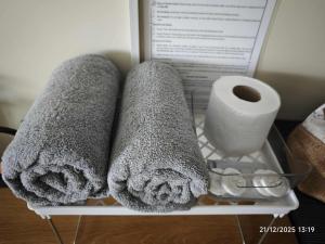 a shelf with towels and a roll of toilet paper at The Comfort Pad in Cagayan de Oro