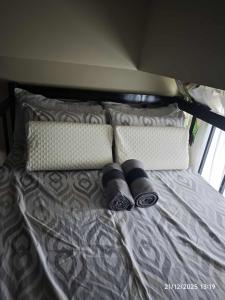 a bed with two pillows at The Comfort Pad in Cagayan de Oro