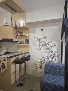 a kitchen with a wall with a tree sticker on it at The Comfort Pad in Cagayan de Oro