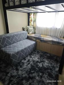a bed in a room with a window at The Comfort Pad in Cagayan de Oro
