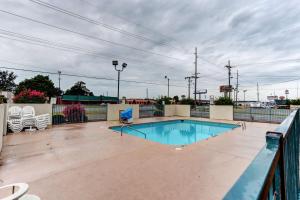 a swimming pool on a patio with a fence at Motel 6 Jonesboro in Jonesboro