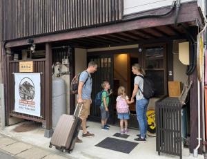 a group of people standing outside of a building at Private House HidaTakayama - Cozy Family Home in Takayama