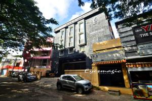 a small car parked in front of a building at Vinayaka Regency in Trivandrum