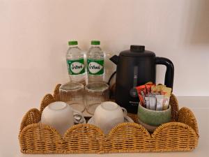 a basket with bottles of water and cups and drinks at Tangerine Villa Patong in Patong Beach