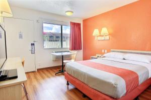 a hotel room with a bed and a desk and a window at Motel 6-Kingsville, TX in Kingsville +54 photos