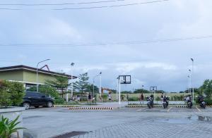a group of people riding motorcycles in a parking lot at Plumera Condo Near Airport Malls & Schools with Elevator125 in Lapu Lapu City