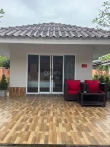 a house with a patio with red pillows on it at All Times Pool Villas in Ban Tha Khun +8 photos
