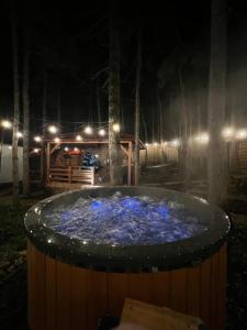 a hot tub at night with lights on it at BoHome Balaton in Balatonakali +246 photos