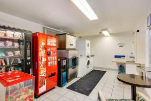 a kitchen with a refrigerator and a washer and dryer at The Jackson SouthTown Motel in Jackson