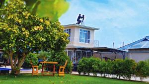 a man standing on top of a house at Serenity Gardens,pool retreat, Kigamboni in Dar es Salaam