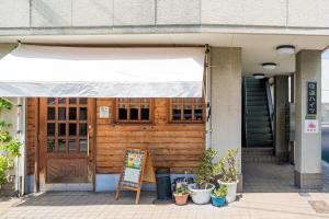 a store front with a sign in front of a building at Peace 平和屋 in Osaka +8 photos