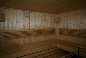 a room with wooden benches and a clock on the wall at Sonnenschlössl Apartments in Neustift im Stubaital
