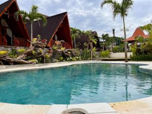 a swimming pool in front of a house at Dalung Tropical in Dalung +7 photos