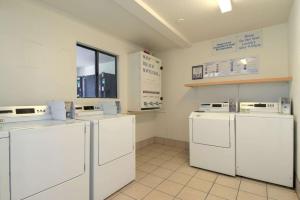 lavadero con lavadoras y secadoras blancas en Motel 6-Chula Vista, CA - San Diego, en Chula Vista