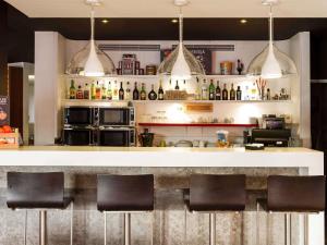 a bar with black chairs in a restaurant at Hotel Ibis Lisboa Sintra in Sintra