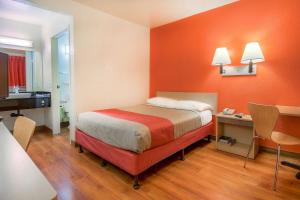 a hotel room with a bed and a desk and a desk at Motel 6-Chino, CA - Los Angeles Area in Chino