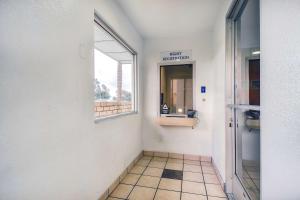 a hallway with a window and a door to a bathroom at Motel 6-Chino, CA - Los Angeles Area in Chino