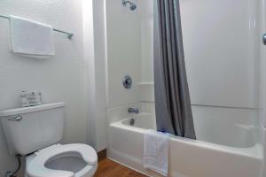 a white bathroom with a toilet and a shower at Motel 6-Chino, CA - Los Angeles Area in Chino