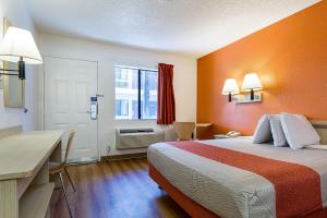 a hotel room with a bed and a desk at Motel 6-Mesa, AZ - South in Mesa