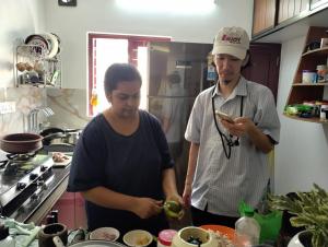 a man and a woman in a kitchen preparing food at Aleenas homestay in Cochin +20 photos