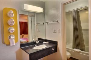 a bathroom with a sink and a mirror at Travelodge by Wyndham Brattleboro VT in Brattleboro