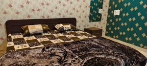 a bedroom with a bed with a chess board on it at Pakwan Restaurant and Rooms in Gorakhpur