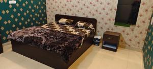 a bedroom with a bed in a room at Pakwan Restaurant and Rooms in Gorakhpur
