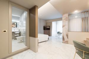 a hotel room with a bed and a bathroom at Baires Guest House in Milan