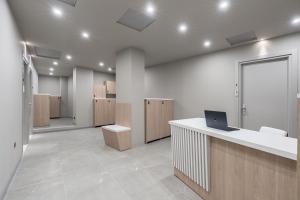 an office with a desk with a laptop on it at Baires Guest House in Milan +37 photos
