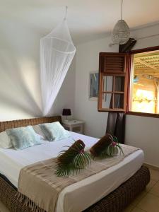 a bedroom with a bed with plants on it at Villa Ticitron in Sainte-Anne +36 photos