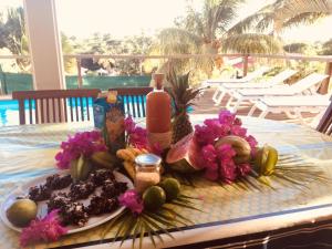 a table with a plate of food and flowers on it at Villa Ticitron in Sainte-Anne