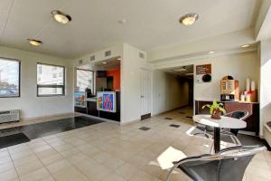 a living room with a table and a kitchen at Motel 6-York, PA - North in York