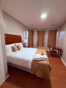a bedroom with a large bed and a desk at Eagle Pamir Guest House in New Haven