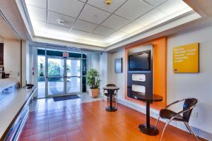 a waiting room in a hospital with a table and chairs at Motel 6-Lewisville, TX - Dallas in Lewisville