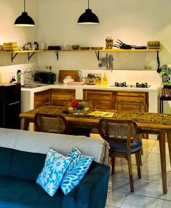 ein Wohnzimmer mit Tisch und Küche in der Unterkunft Little Munduk, full private villa in Munduk