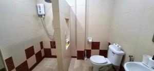 a bathroom with a toilet and a sink at Pharos Apartments in Nathon Bay