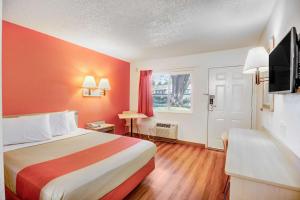a hotel room with a bed and a television at Motel 6-Stockton, CA - North in Lincoln Village