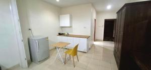 a kitchen with a small table and a refrigerator at Pharos Apartments in Nathon Bay
