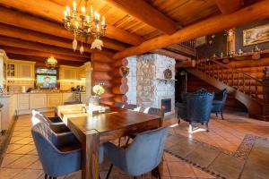 a kitchen and dining room with a wooden table and chairs at Srub Eden in Frýdek-Místek +4 photos