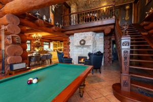 a pool table in a room with a fireplace at Srub Eden in Frýdek-Místek