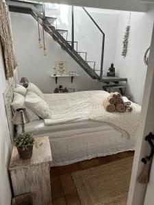 a bedroom with a bed with a staircase in it at Cozy Townhouse Altea in Altea