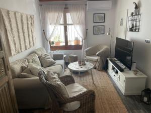 a living room with a couch and a tv at Cozy Townhouse Altea in Altea