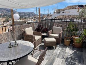 a patio with chairs and a table and a table and chairs at Cozy Townhouse Altea in Altea