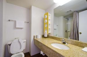 a bathroom with a sink and a toilet and a mirror at Motel 6-Springfield, DC - Washington Southwest in Springfield
