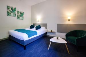 En eller flere senge i et værelse på Hotel De La Pommeraie