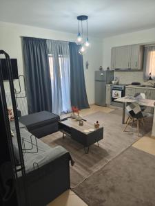 a living room with a couch and a table at Alkyona apartments in Kalavrita +2 photos