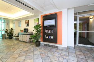 a atm machine in a lobby with an orange wall at Motel 6-Colchester, VT - Burlington in Burlington +45 photos